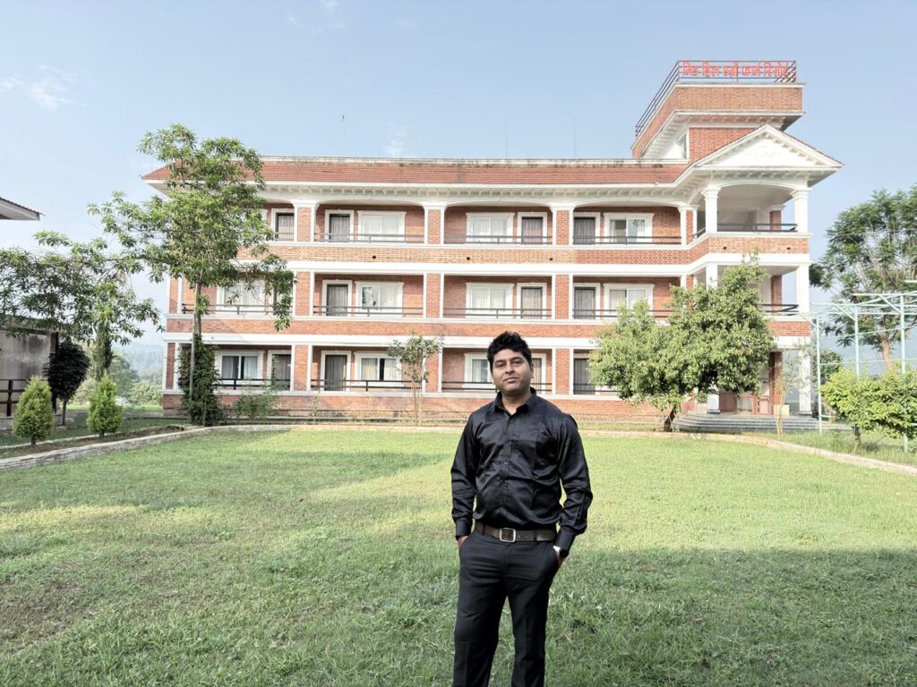 Mr. Universe in black dress in Mid Hill Agro Farm Resort infront of main buliding