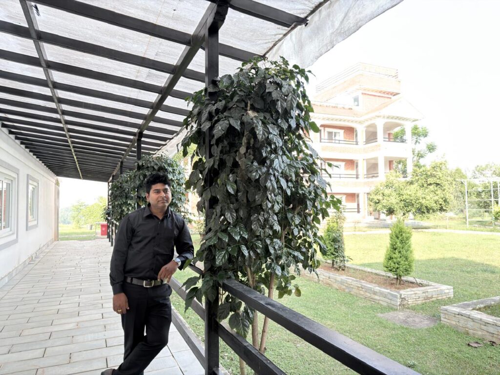 Mr. Universe poses in the hallway of the Mid Hill Agro Farm Resort's dining hall.